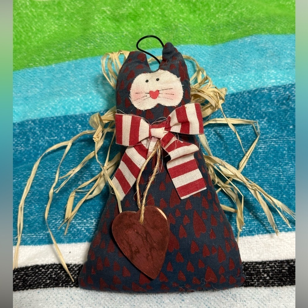 Cute cat angel with raffia wings and metal halo.